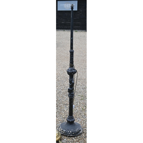 515 - # An ebonised wood standard lamp, carved with a cherub standard lamp, 183cm