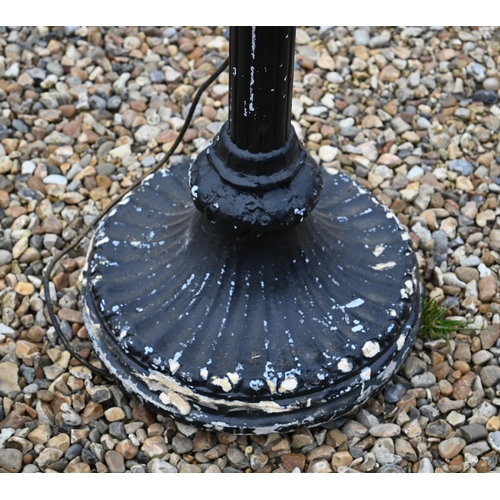 515 - # An ebonised wood standard lamp, carved with a cherub standard lamp, 183cm