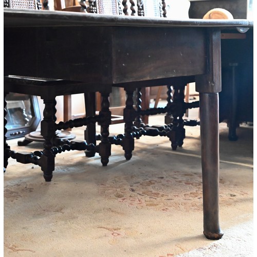 401 - A mahogany extending dining table with drop leaf top and three leaves on turned pad-footed supports,... 