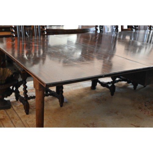 401 - A mahogany extending dining table with drop leaf top and three leaves on turned pad-footed supports,... 