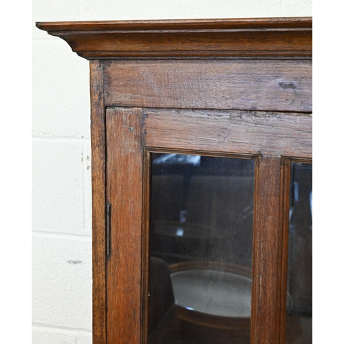 14 - A rustic stained hardwood cabinet with glazed doors (one pane cracked), 120 cm wide x 50 cm deep x 1... 