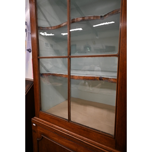 62 - A 19th century mahogany cabinet bookcase with glazed doors over panelled cupboards on bracket feet, ... 