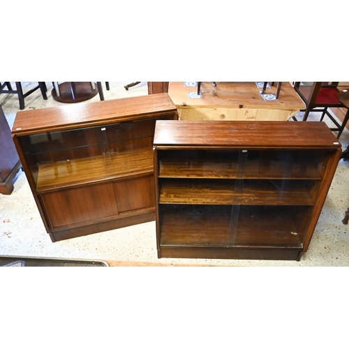 135 - # A companion pair of mid-century slope fronted teak cabinets with glass sliding doors, one with cup... 