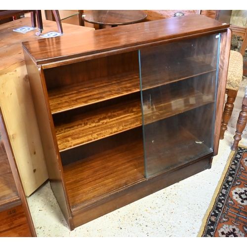 135 - # A companion pair of mid-century slope fronted teak cabinets with glass sliding doors, one with cup... 