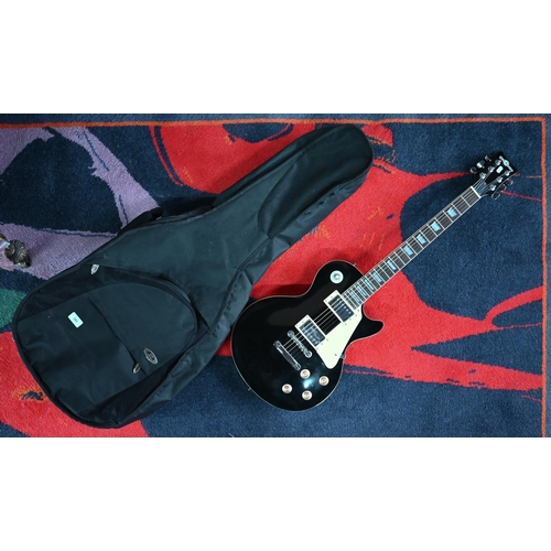 496 - A 'Gear 4 Music' Gibson (Les Paul shape) electric guitar (black body with cream trim) to/w Ritter so... 