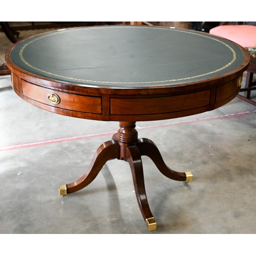 100 - A Regency style mahogany drum table with gilt tooled green leather top, 100 cm diam x 74 cm high