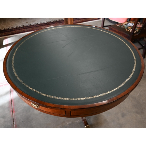 100 - A Regency style mahogany drum table with gilt tooled green leather top, 100 cm diam x 74 cm high