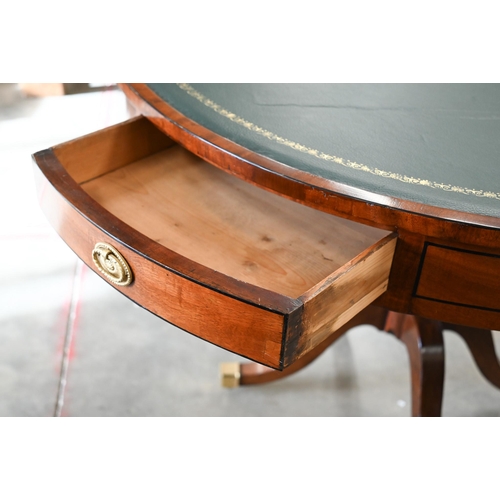 100 - A Regency style mahogany drum table with gilt tooled green leather top, 100 cm diam x 74 cm high