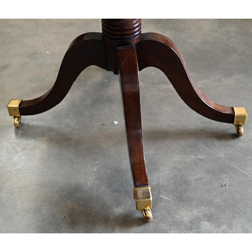 100 - A Regency style mahogany drum table with gilt tooled green leather top, 100 cm diam x 74 cm high