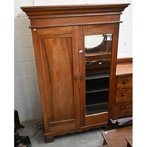 101 - An Indian rosewood compactum wardrobe with full length mirrored and panelled doors enclosing hanging... 