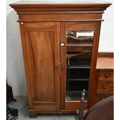 101 - An Indian rosewood compactum wardrobe with full length mirrored and panelled doors enclosing hanging... 