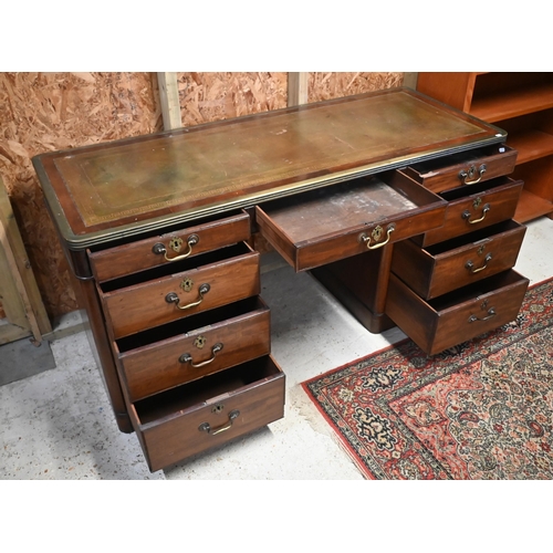 110 - A 19th century mahogany and brass mounted twin pedestal desk with gilt tooled green leather top over... 