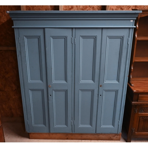 114 - A blue painted compactum wardrobe with two pairs of panelled doors, 140 cm wide x 48 cm deep x 174 c... 