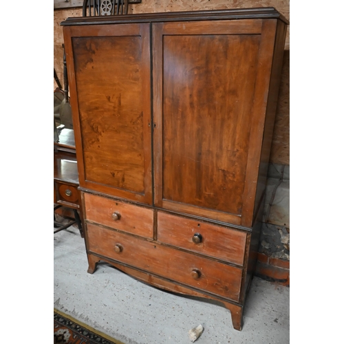 115 - A 19th century mahogany linen press, the top with panelled doors enclosing five slides on three draw... 