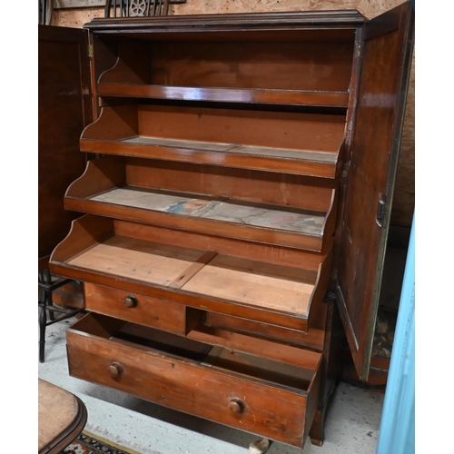 115 - A 19th century mahogany linen press, the top with panelled doors enclosing five slides on three draw... 