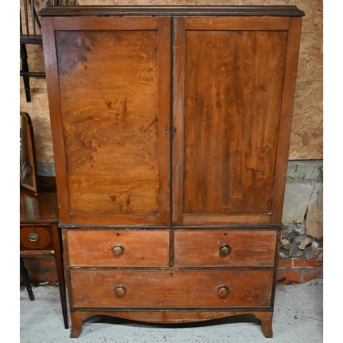 115 - A 19th century mahogany linen press, the top with panelled doors enclosing five slides on three draw... 