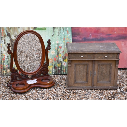 129 - A carved mahogany framed oval toilet mirror to/w small oak table-top cabinet (2)