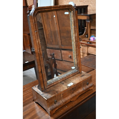 134 - A 19th century walnut toilet mirror on three drawer platform base