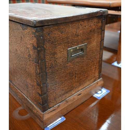 23 - An antique dove-tailed elm trunk with hinged top and flush brass campaign style handles, 66 x 36 x 4... 