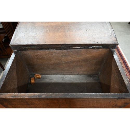 23 - An antique dove-tailed elm trunk with hinged top and flush brass campaign style handles, 66 x 36 x 4... 