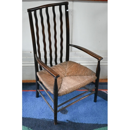 Early 20th century beech and ash Liberty style child's elbow chair with woven rush seat
