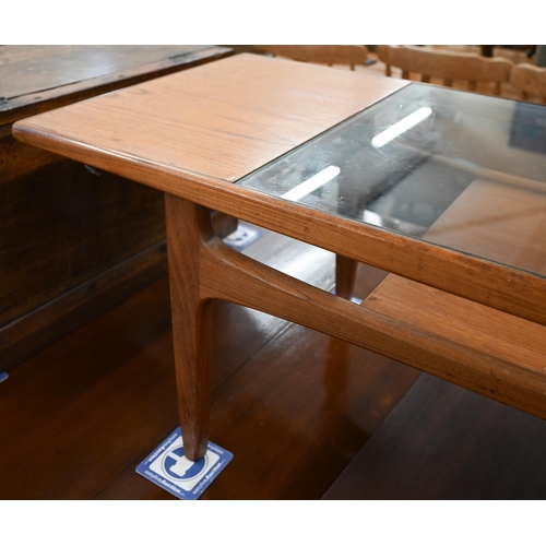 24 - A mid-century G-Plan (unmarked) teak coffee table with inset central glass panel over open undertier... 