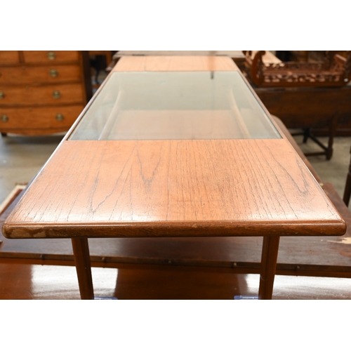 24 - A mid-century G-Plan (unmarked) teak coffee table with inset central glass panel over open undertier... 