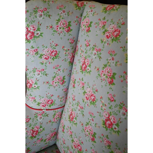 26 - An Edwardian wingback armchair with Cath Kidston style floral fabric upholstery