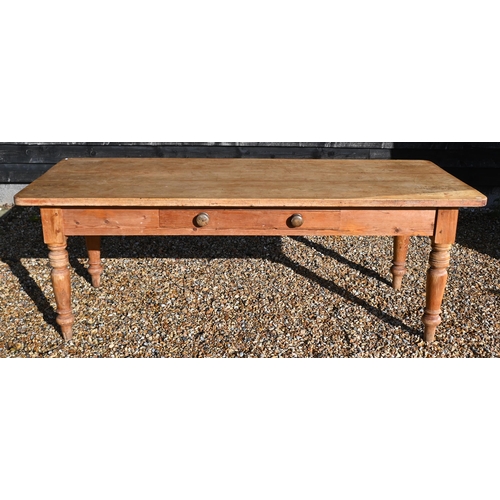 31 - A vintage pine farmhouse dining table with single drawer and turned supports, 214 cm wide x 90 cm de... 