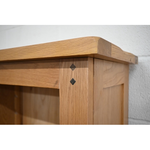 33 - A modern oak open bookcase with adjustable shelves on three drawer base, 186 cm wide x 34 cm deep x ... 