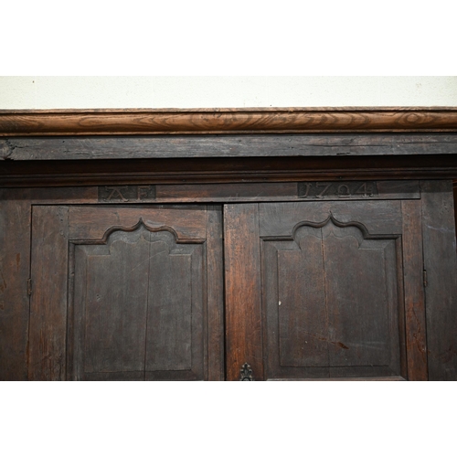 34 - An 18th century and later oak livery cupboard with panelled doors on base with two drawers below dum... 