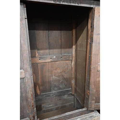 34 - An 18th century and later oak livery cupboard with panelled doors on base with two drawers below dum... 