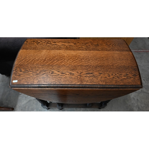 38 - An early 20th century oak drop leaf table on barleytwist gateleg action base, 105 x 75 x 74 cm high