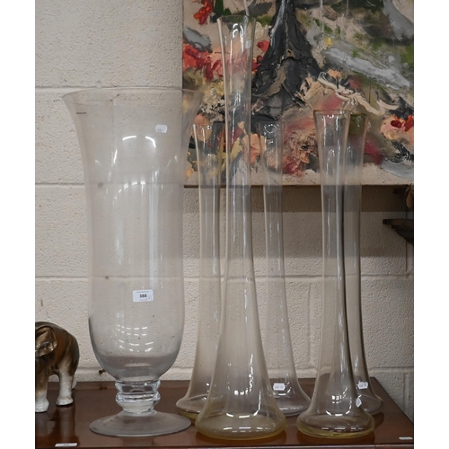 388 - A large glass vase on short-stemmed foot, 69 cm high, to/w a 79 cm high vase flute and four matching... 