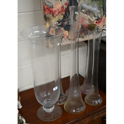 388 - A large glass vase on short-stemmed foot, 69 cm high, to/w a 79 cm high vase flute and four matching... 