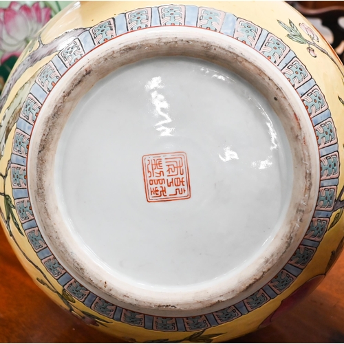 397 - A large Chinese porcelain bottle vase, painted with peaches, flowering prunus and bats, on a yellow ... 