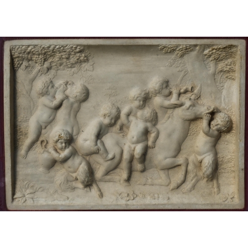 402 - A framed relief plaque depicting Bacchanalian putti, 11 x 16 cm