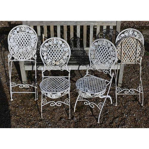 413 - A painted metal lattice-work patio set comprising table, four chairs, two parasols to/w painted wrou... 