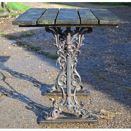 415 - A weathered teak and cast iron garden table, 90 cm wide x 66 cm deep x 72 cm high to/w a somewhat si... 