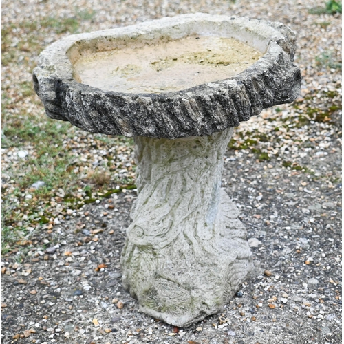 428 - A naturalistic reconstituted two piece cast stone bird bath to/w iron wagon wheel (2)