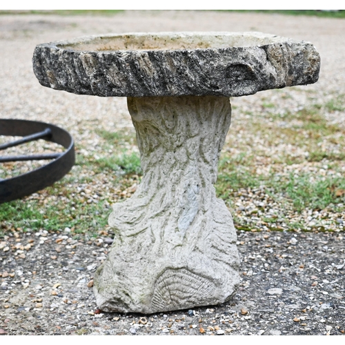 428 - A naturalistic reconstituted two piece cast stone bird bath to/w iron wagon wheel (2)