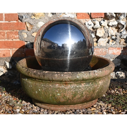 429 - A contemporary stainless steel solar panelled spherical water feature in weathered terracotta bowl