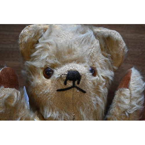 433 - A vintage red-plush teddy-bear with glass eyes, stitched nose and rotating limbs with replacement pa... 