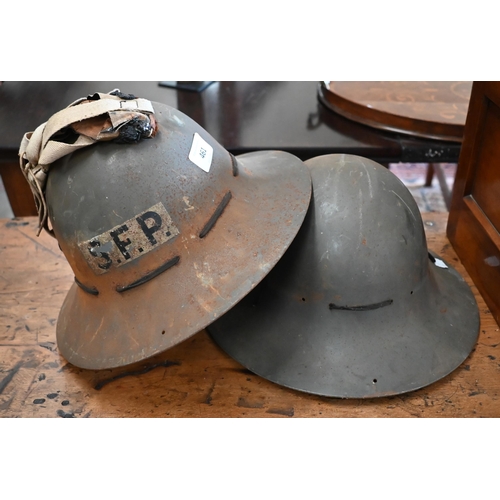 461 - Two World War II British Civil Defence Kuckermann steel helmets - one stencilled 'SFP' (2)