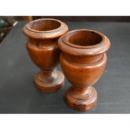 465 - A small pair of turned fruitwood urns, 13.5 cm (2)