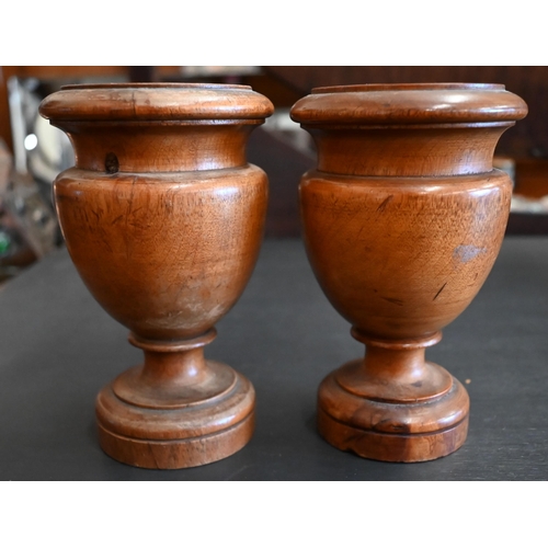 465 - A small pair of turned fruitwood urns, 13.5 cm (2)