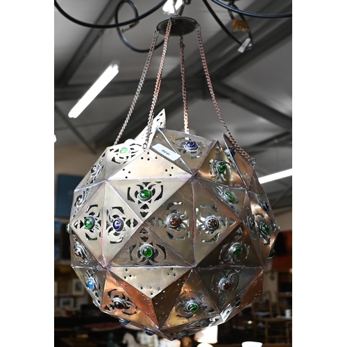 466 - A Middle Eastern pierced copper ceiling lightshade of faceted globular form, set with coloured glass... 