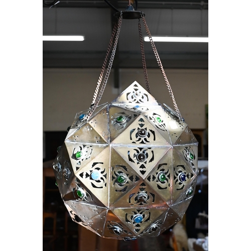 466 - A Middle Eastern pierced copper ceiling lightshade of faceted globular form, set with coloured glass... 