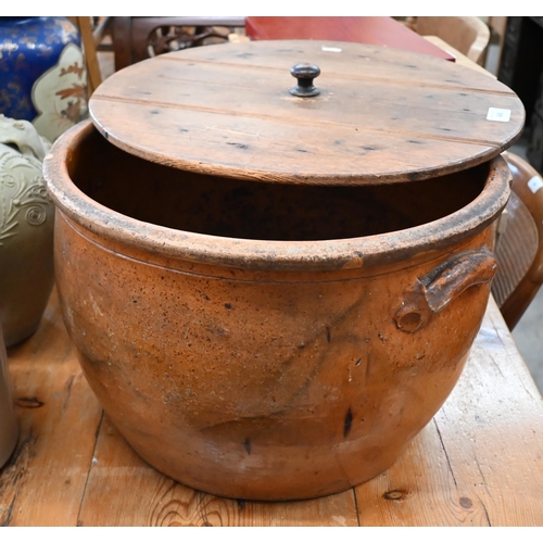 468 - An antique glazed earthenware bread-crock with planked pine lid 46 cm diam to/w a Middle Eastern wat... 