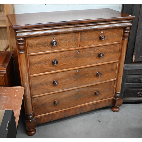 56 - A large Victorian figured mahogany chest with shallow cavetto drawer over two short and three long d... 